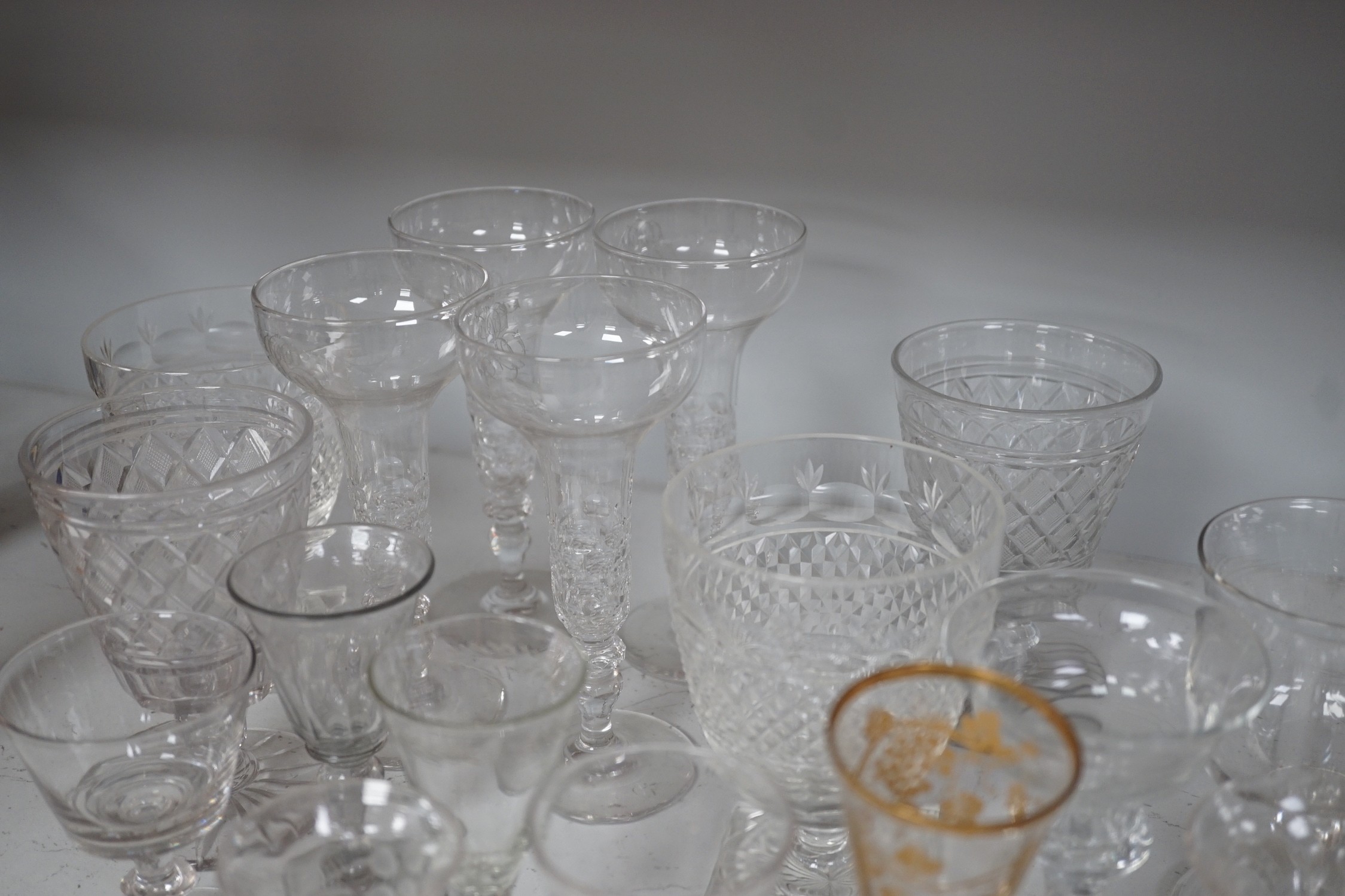 A quantity of assorted 18th / 19th century and later clear drinking glasses including a damaged James Giles gilt decorated opaque twist stem wine glass.
